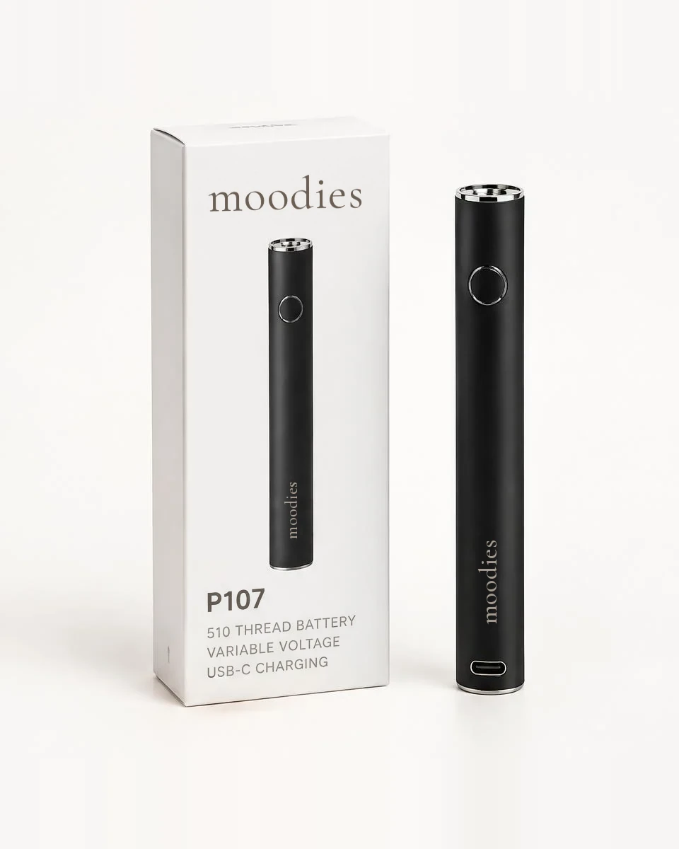 Moodies P107 510 thread push battery in midnight black beside its white Moodies box